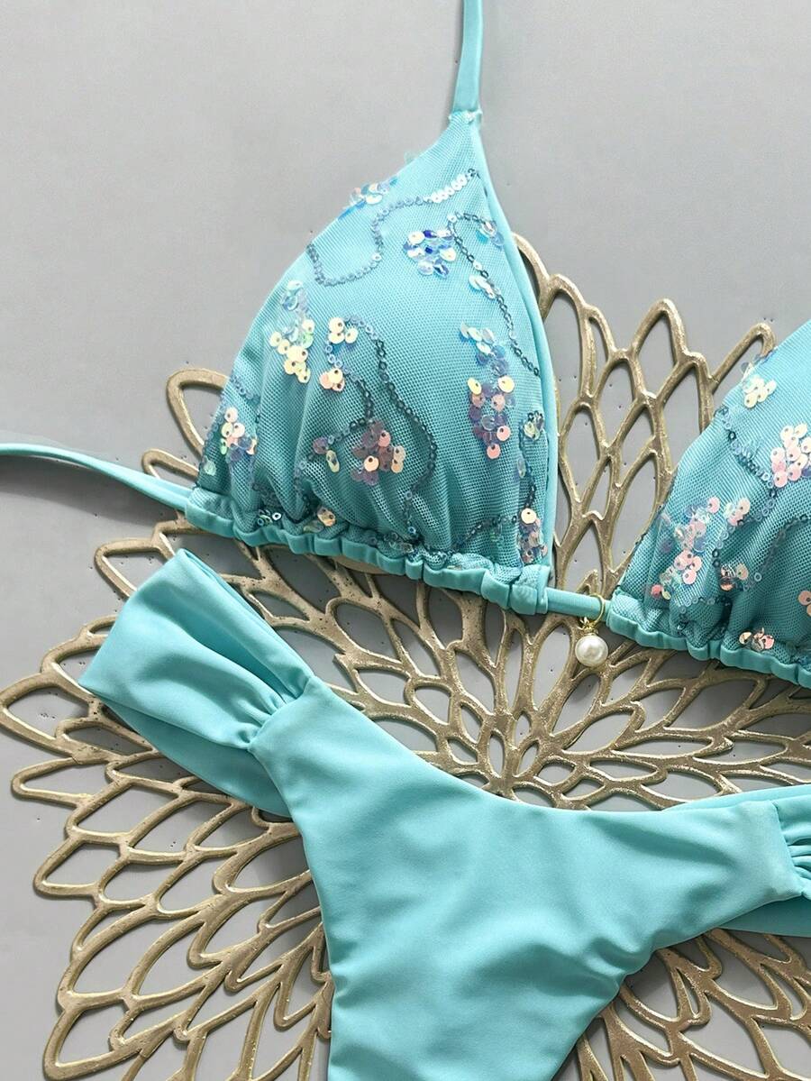 Women's 2-piece triangle cup bikini set in solid color featuring woven pearl shell decoration, halter neckline, and high-waist side-tie ruched bottoms.