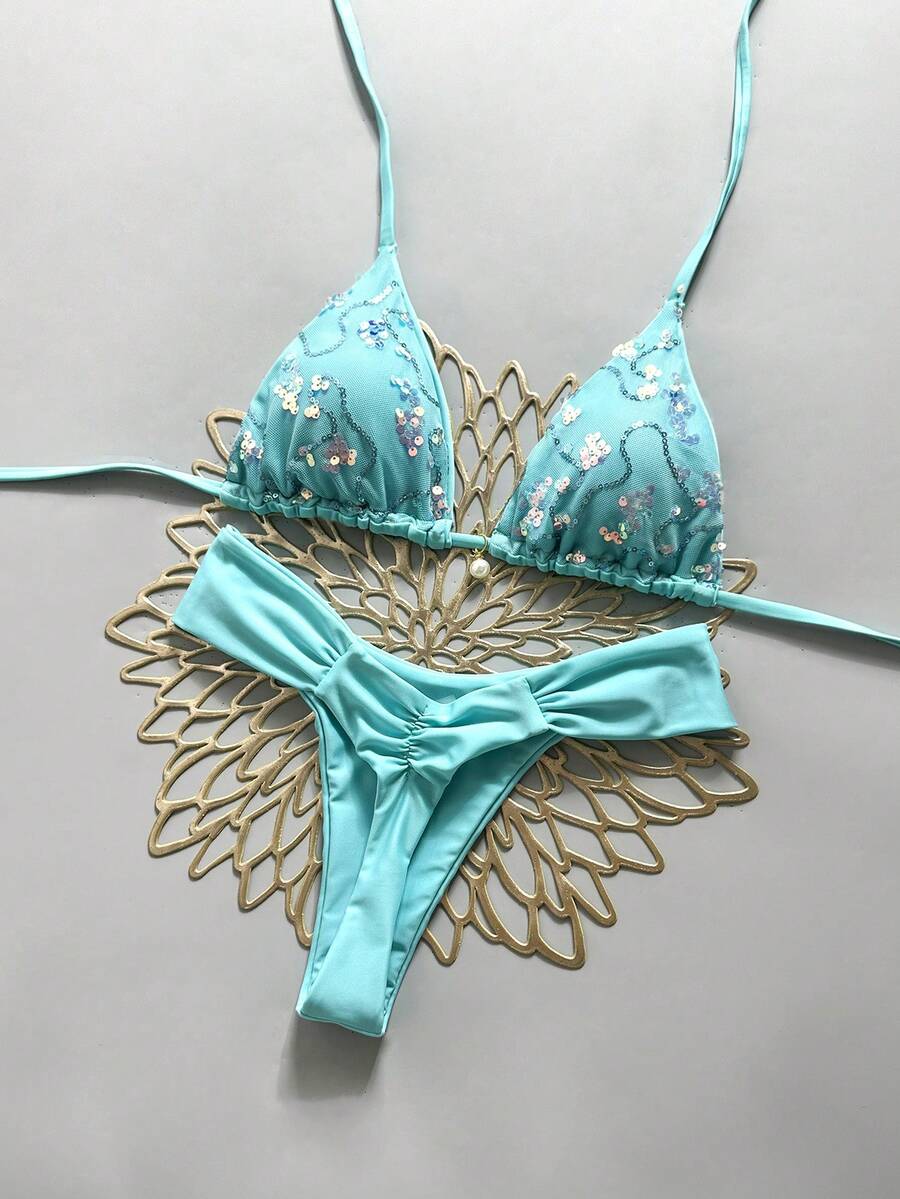 Women's 2-piece triangle cup bikini set in solid color featuring woven pearl shell decoration, halter neckline, and high-waist side-tie ruched bottoms.