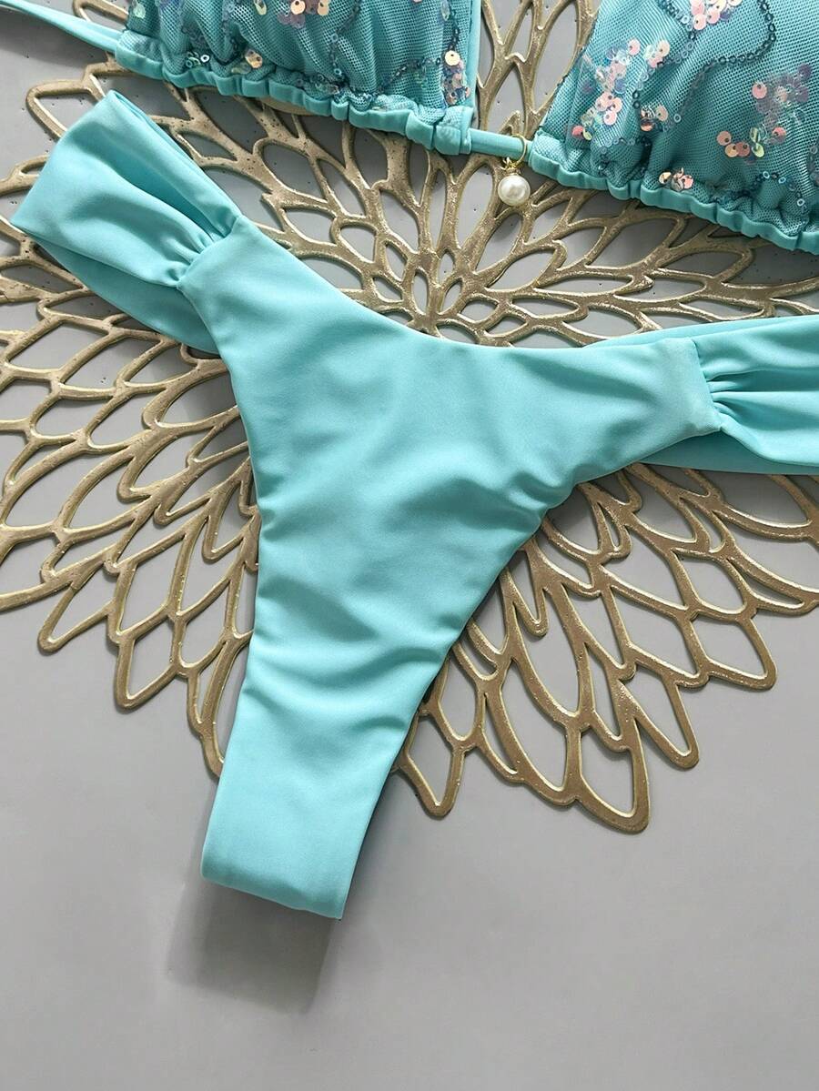 Women's 2-piece triangle cup bikini set in solid color featuring woven pearl shell decoration, halter neckline, and high-waist side-tie ruched bottoms.