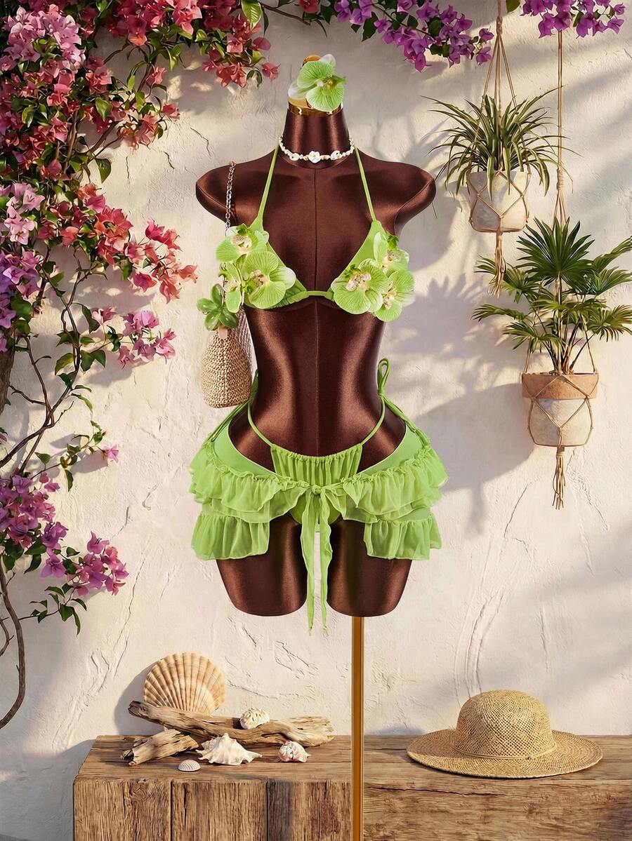 Women's 3-piece blue bikini swimwear set featuring a crop top with 3D rose accents, tie back detail, spaghetti straps, and tie-side bottoms.