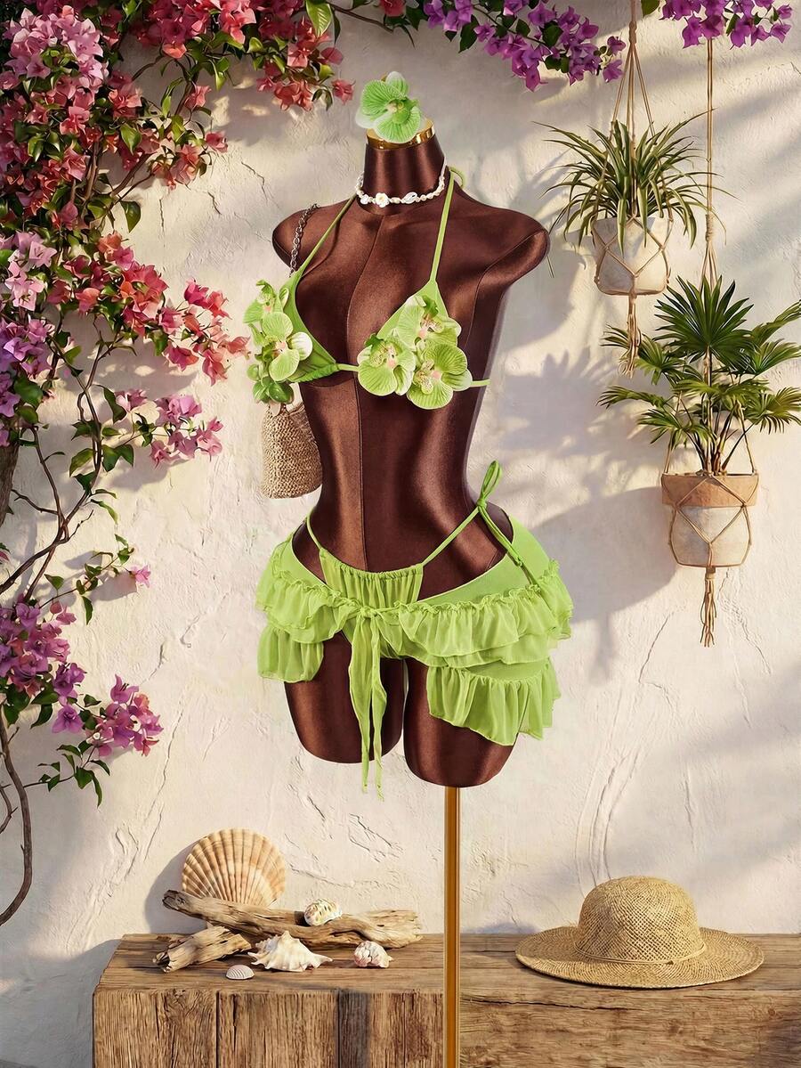 Women's 3-piece blue bikini swimwear set featuring a crop top with 3D rose accents, tie back detail, spaghetti straps, and tie-side bottoms.