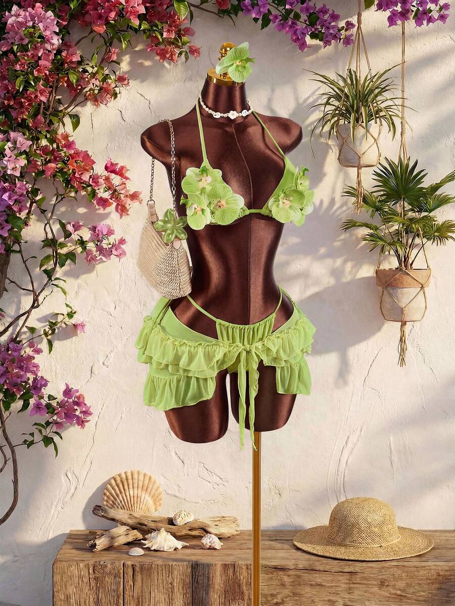 Women's 3-piece blue bikini swimwear set featuring a crop top with 3D rose accents, tie back detail, spaghetti straps, and tie-side bottoms.