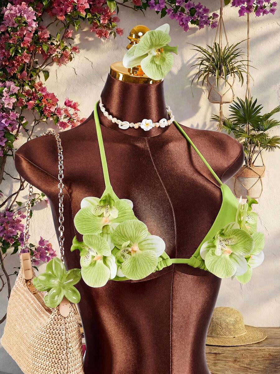 Women's 3-piece blue bikini swimwear set featuring a crop top with 3D rose accents, tie back detail, spaghetti straps, and tie-side bottoms.