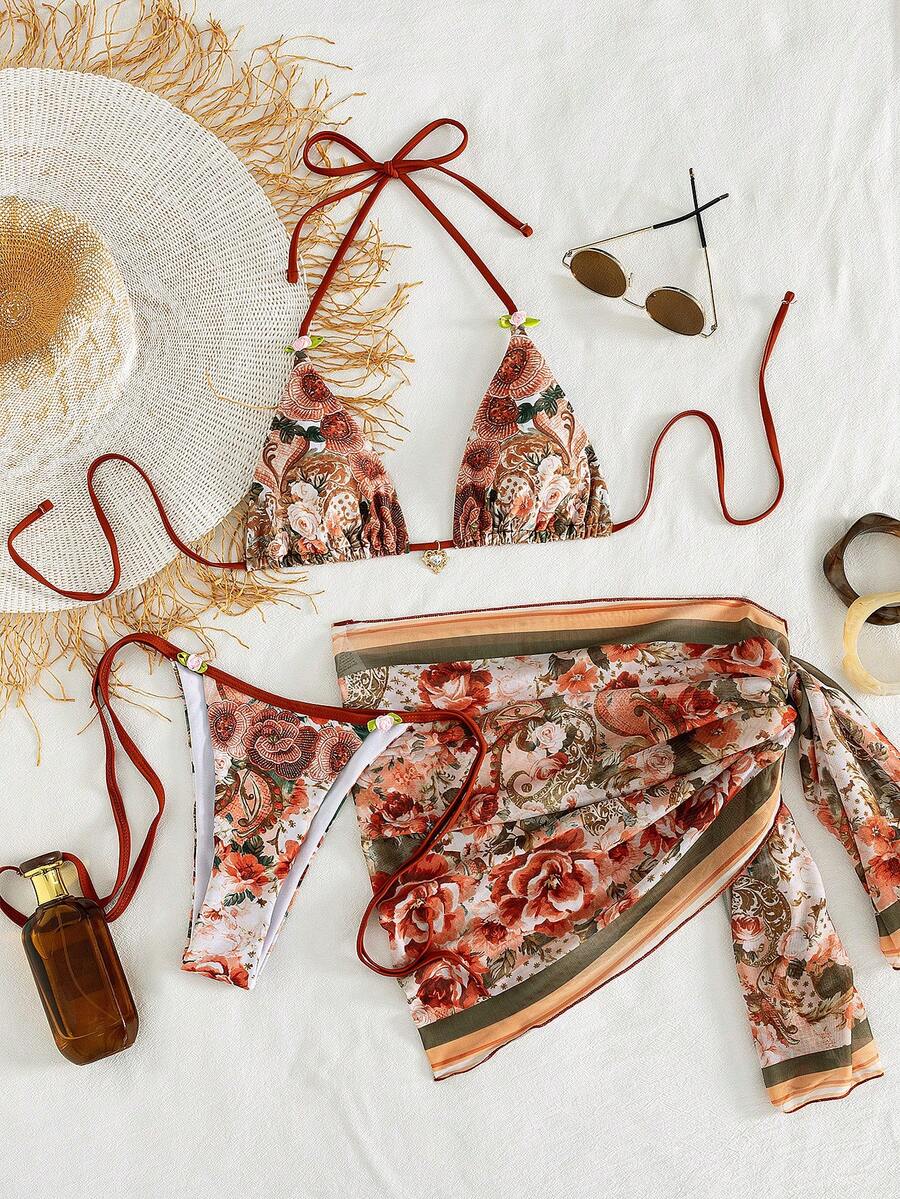 Women's 3-piece pink floral print bikini set featuring a wireless halter top with removable padding and matching tie-side swim bottoms.