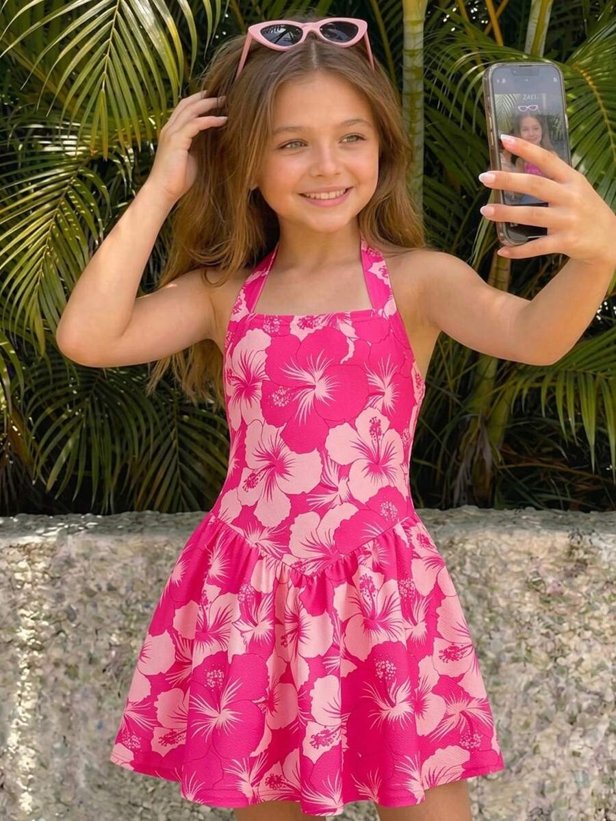 Black sleeveless halter polka dot mini dress for tween girls featuring a high waist and flared hem