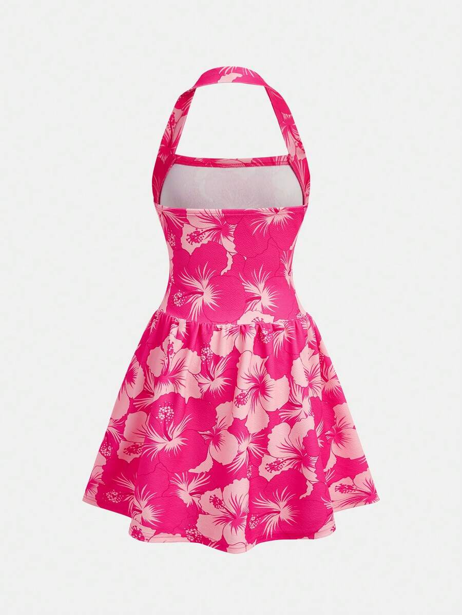 Black sleeveless halter polka dot mini dress for tween girls featuring a high waist and flared hem