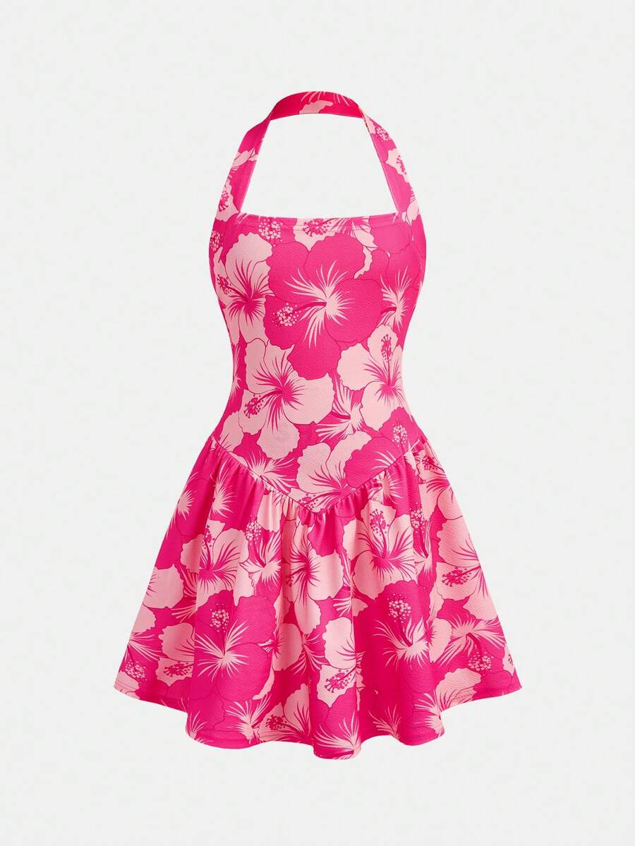 Black sleeveless halter polka dot mini dress for tween girls featuring a high waist and flared hem