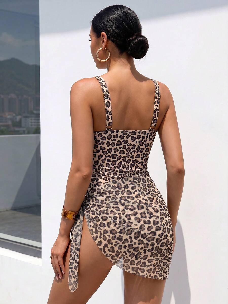 Women's black floral print plunge neck one-piece swimsuit featuring cut-out detail paired with a matching knee-length mesh cover-up skirt