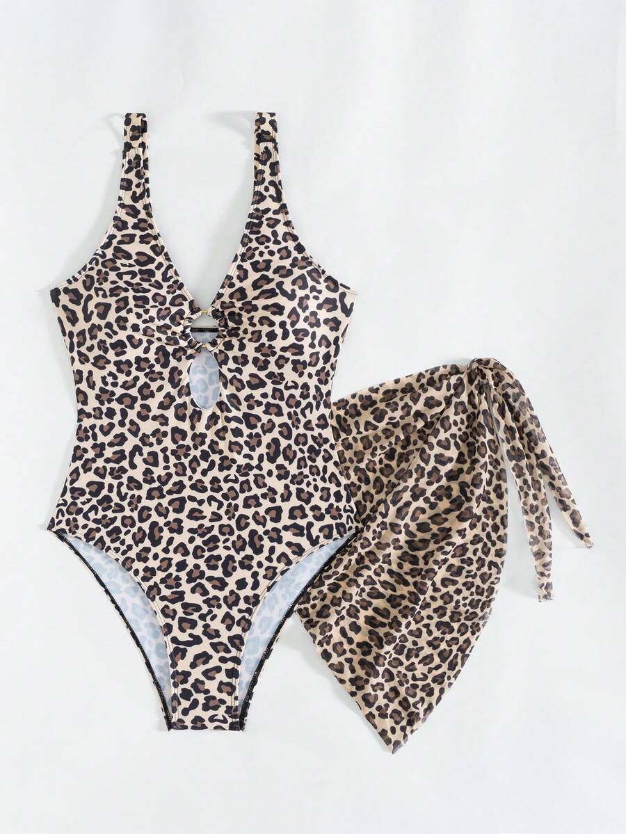 Women's black floral print plunge neck one-piece swimsuit featuring cut-out detail paired with a matching knee-length mesh cover-up skirt