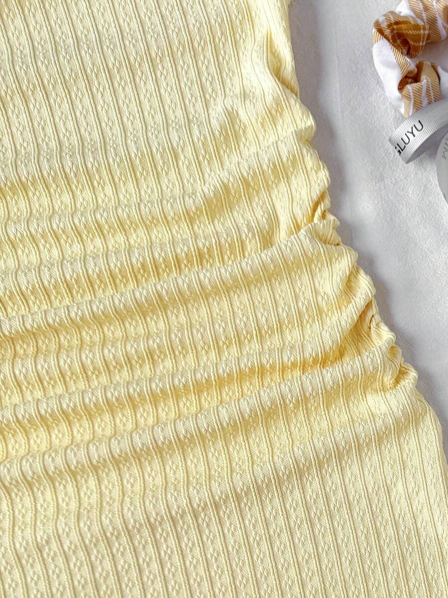 Yellow asymmetrical neck slim fit dress for tween girls with sleeveless design, plain textured knit fabric, natural waist, and pencil hem