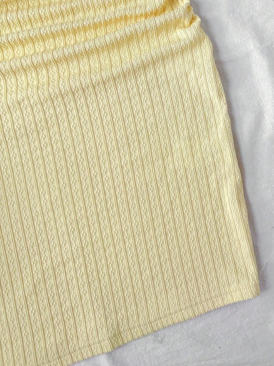 Yellow asymmetrical neck slim fit dress for tween girls with sleeveless design, plain textured knit fabric, natural waist, and pencil hem
