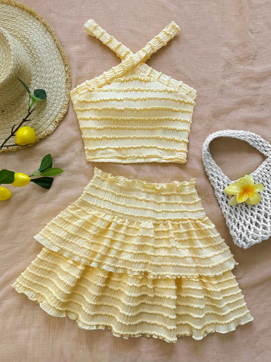 Tween girls blue and white 2-piece set with a striped halter neck vest top and a floral high-waist tiered paperbag skirt.