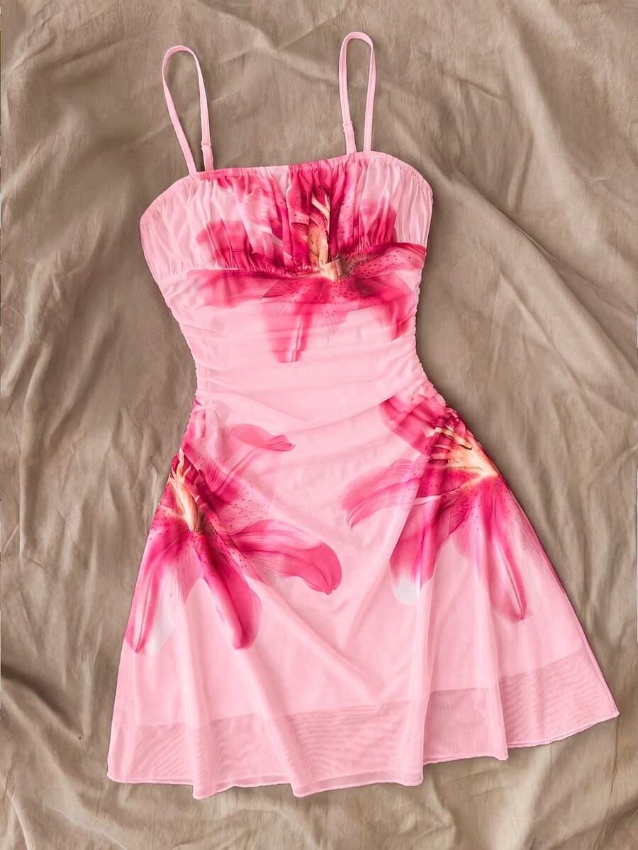 Tween girl yellow mini sundress with large pink floral hibiscus print, spaghetti straps, high waist, flared hem, and sleeveless cami style for summer beach wear