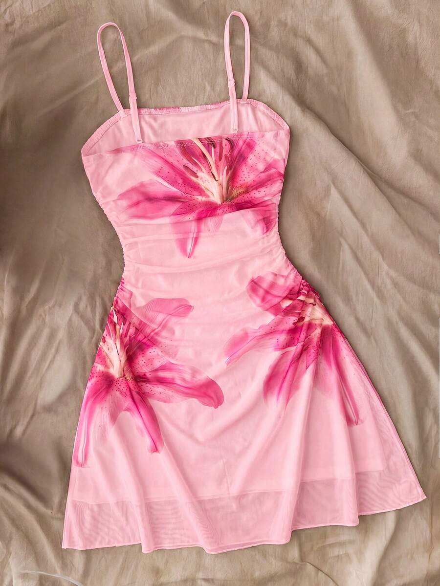 Tween girl yellow mini sundress with large pink floral hibiscus print, spaghetti straps, high waist, flared hem, and sleeveless cami style for summer beach wear