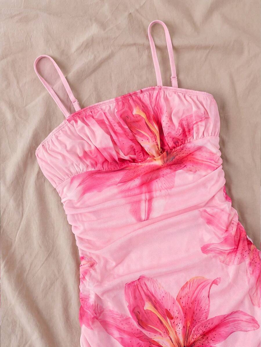 Tween girl yellow mini sundress with large pink floral hibiscus print, spaghetti straps, high waist, flared hem, and sleeveless cami style for summer beach wear
