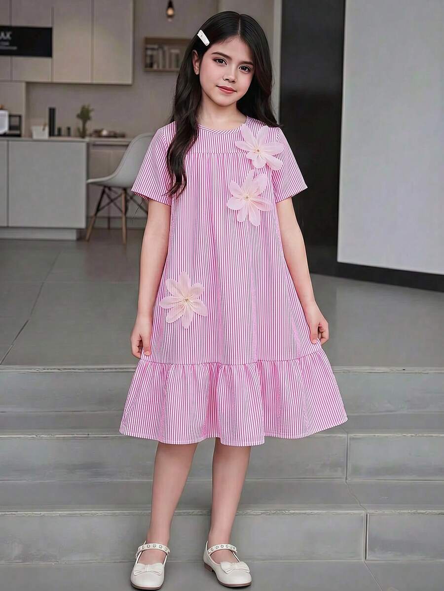 Tween girl wearing an Army Green textured short sleeve smock midi dress with round neck and ruffle flounce hem.