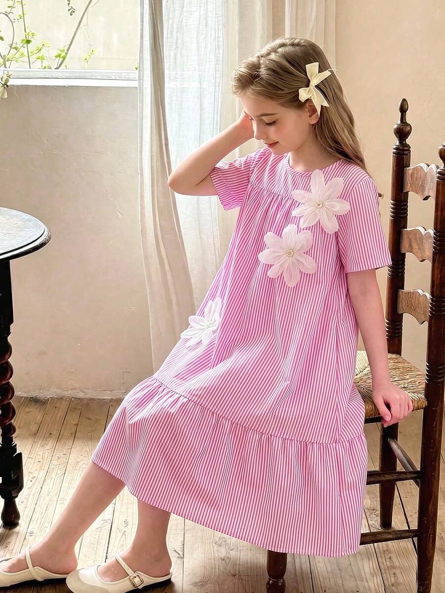 Tween girl wearing an Army Green textured short sleeve smock midi dress with round neck and ruffle flounce hem.