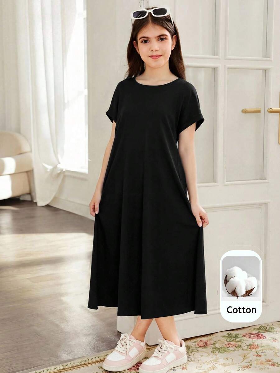 Tween girls casual black A-line long dress featuring short sleeves, a round neckline, and a decorative front bow with contrast lace trim.
