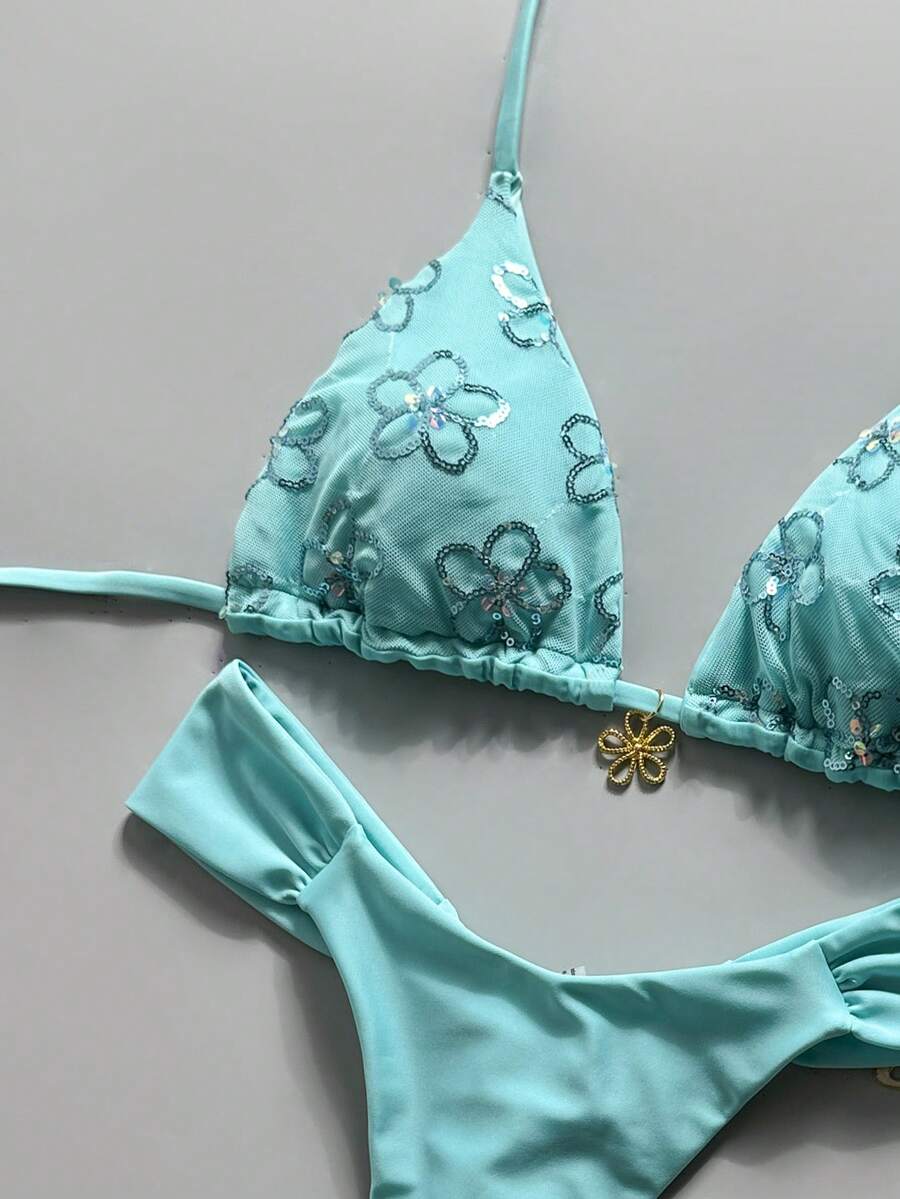 Women's 2-piece triangle cup bikini set in solid color featuring woven pearl shell decoration, halter neckline, and high-waist side-tie ruched bottoms.