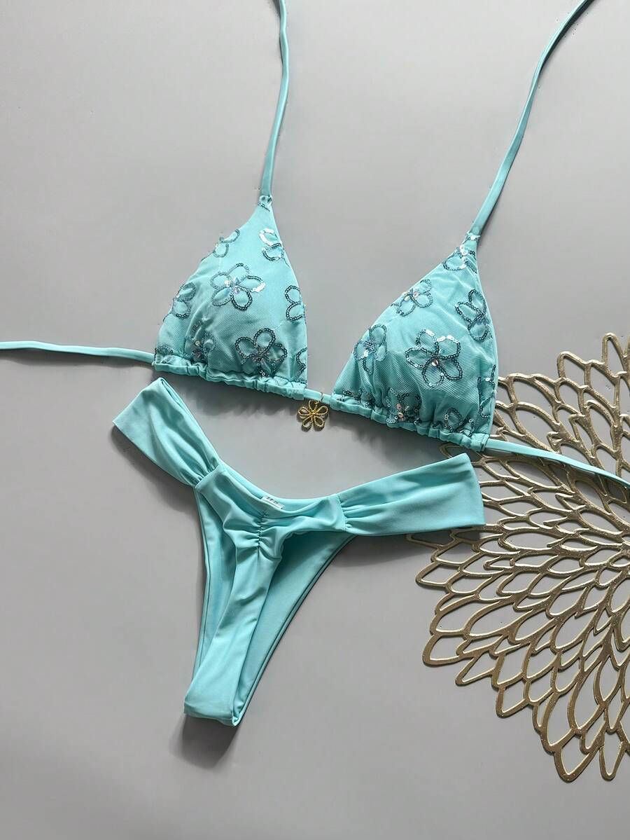 Women's 2-piece triangle cup bikini set in solid color featuring woven pearl shell decoration, halter neckline, and high-waist side-tie ruched bottoms.