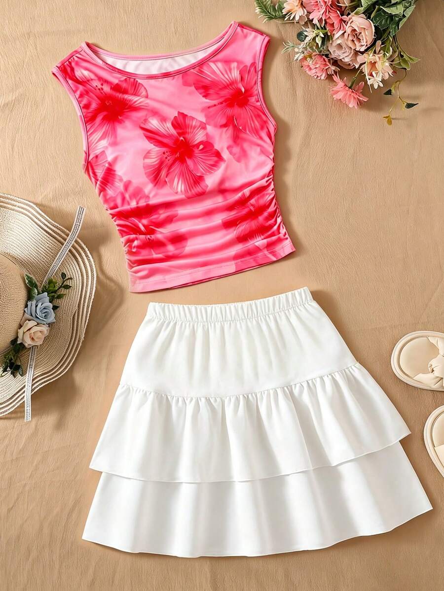 Light blue two-piece outfit set for tween girls with a sleeveless round neck vest top and a tiered ruffle cake skirt featuring a plant pattern.