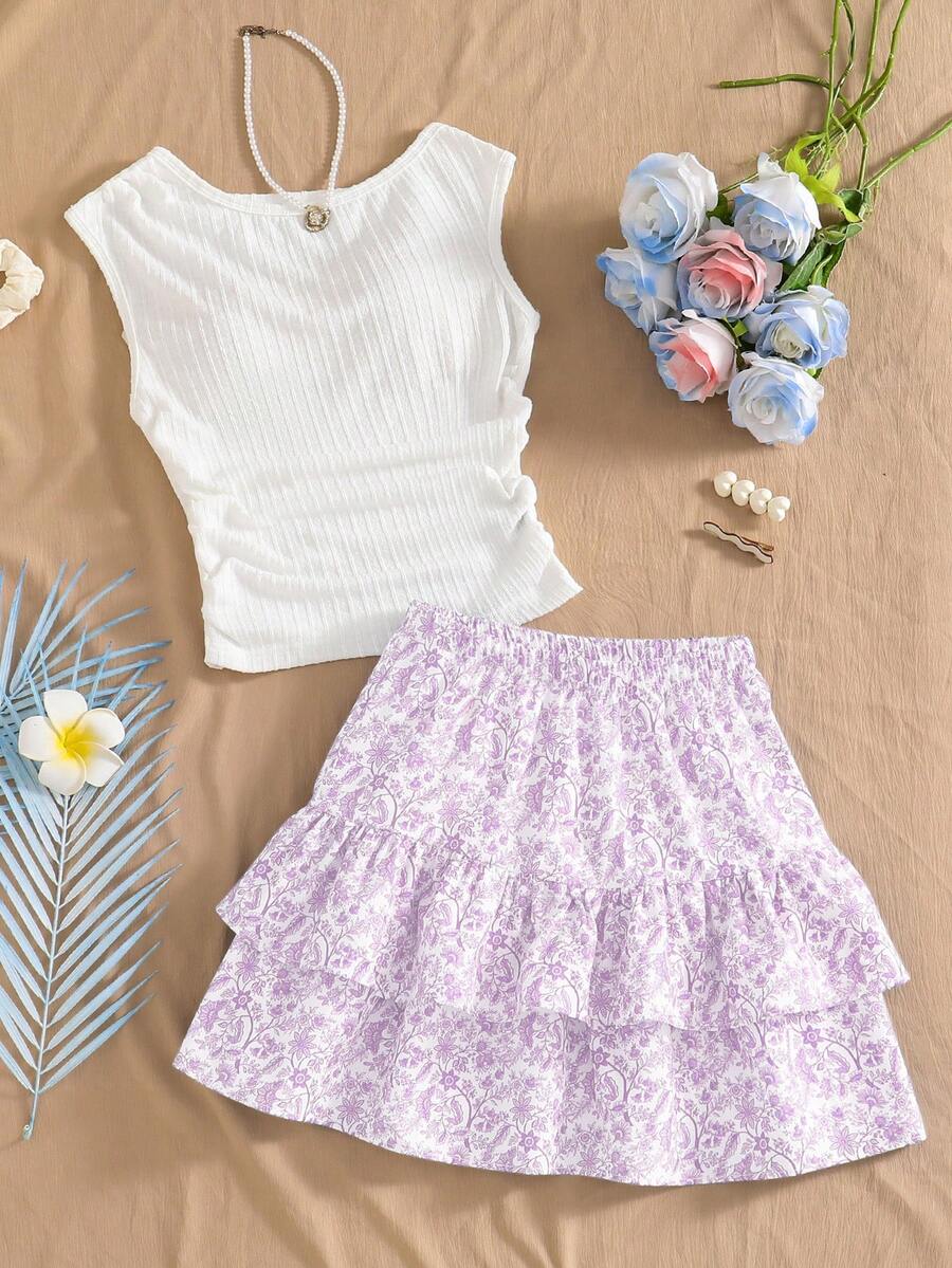 Light blue two-piece outfit set for tween girls with a sleeveless round neck vest top and a tiered ruffle cake skirt featuring a plant pattern.