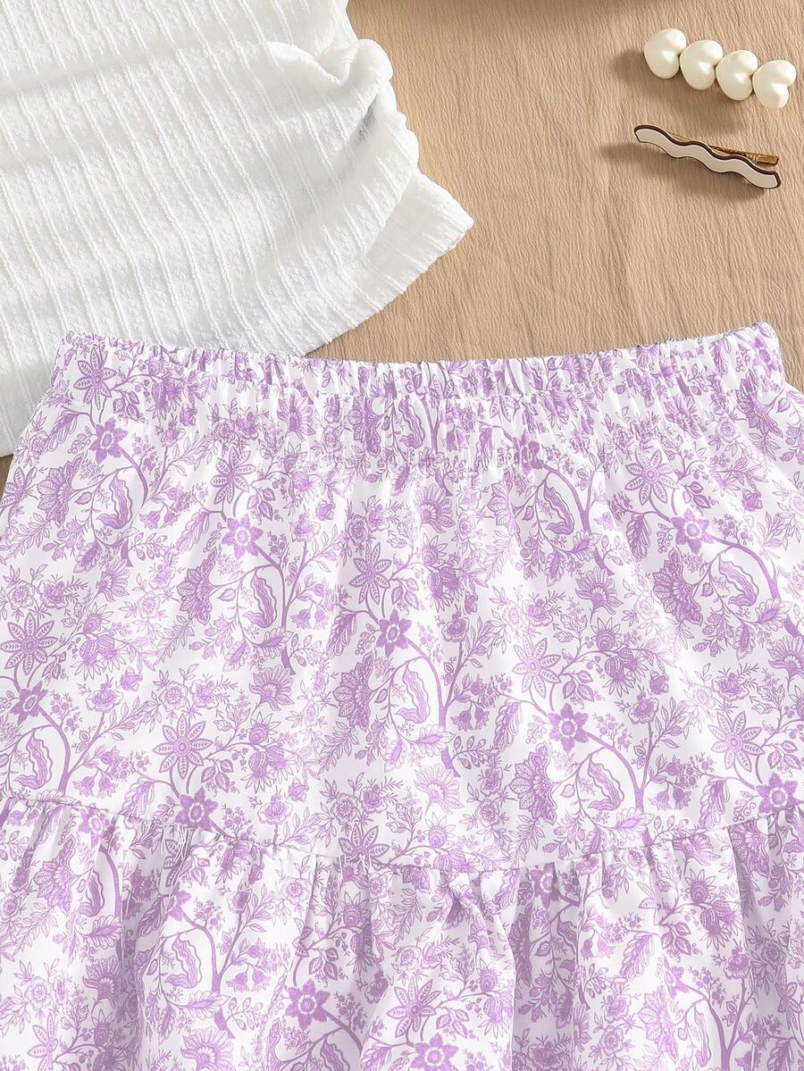 Light blue two-piece outfit set for tween girls with a sleeveless round neck vest top and a tiered ruffle cake skirt featuring a plant pattern.