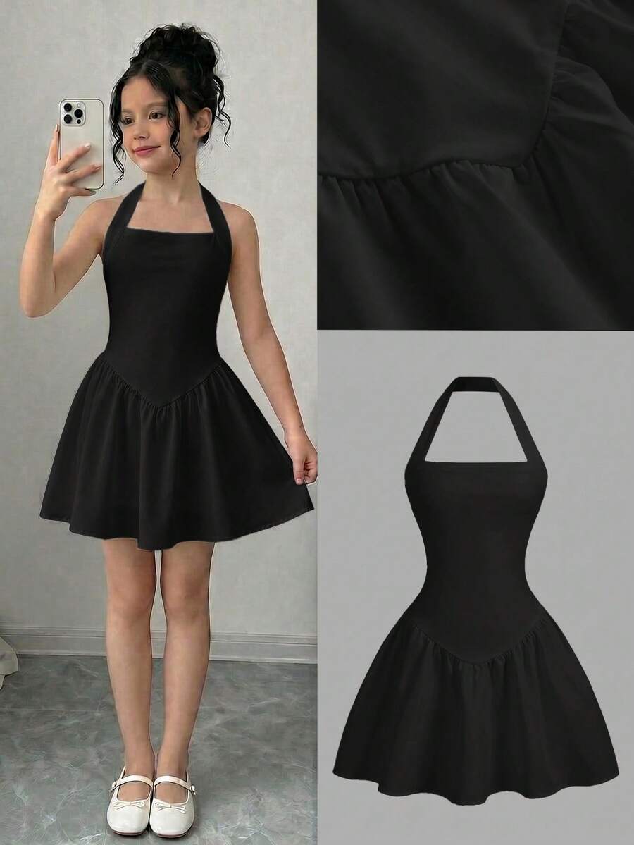 Black sleeveless halter polka dot mini dress for tween girls featuring a high waist and flared hem