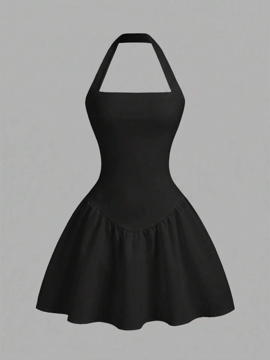 Black sleeveless halter polka dot mini dress for tween girls featuring a high waist and flared hem