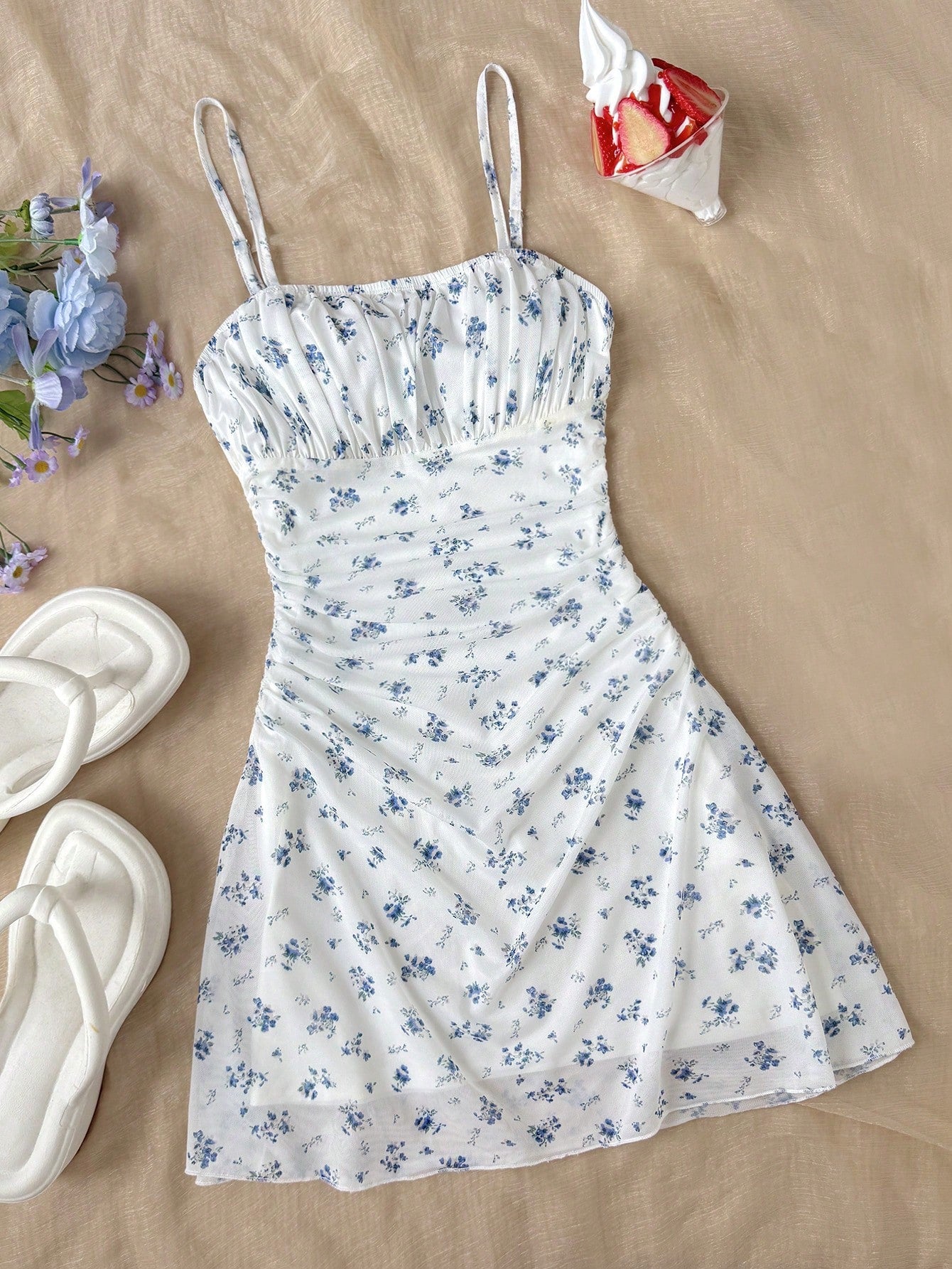 Tween girl yellow mini sundress with large pink floral hibiscus print, spaghetti straps, high waist, flared hem, and sleeveless cami style for summer beach wear
