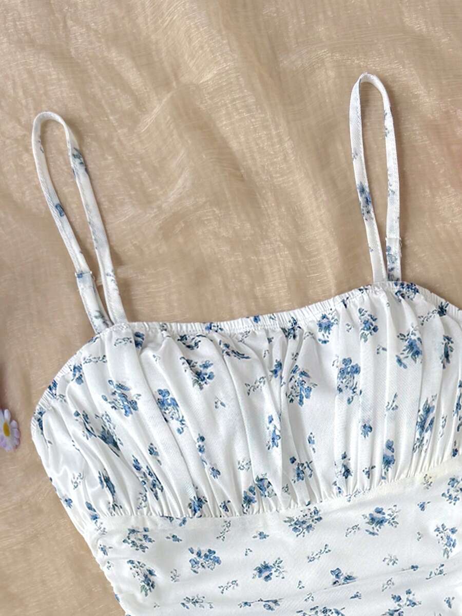 Tween girl yellow mini sundress with large pink floral hibiscus print, spaghetti straps, high waist, flared hem, and sleeveless cami style for summer beach wear