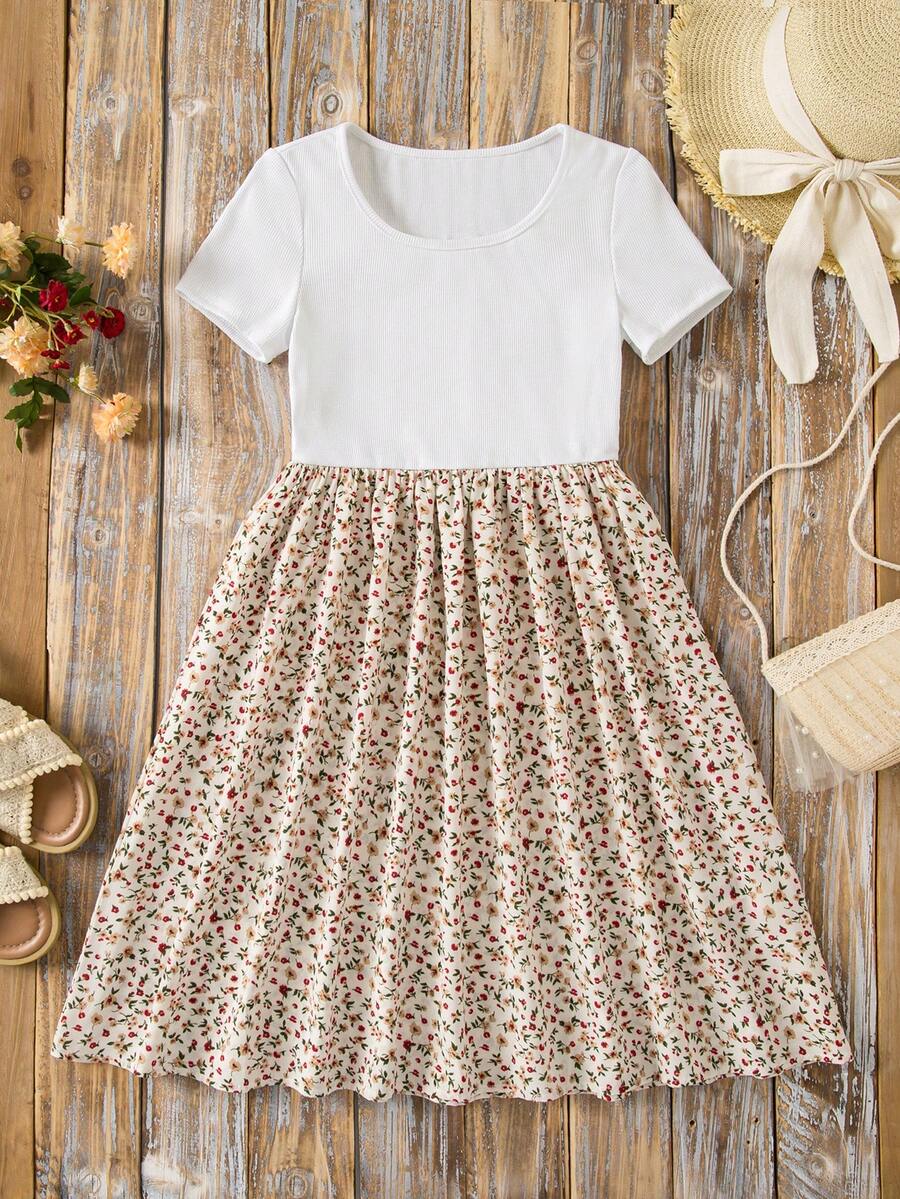 Tween girl wearing an apricot short sleeve A-line dress featuring a round neck, high waist with a belt, and flared hem.