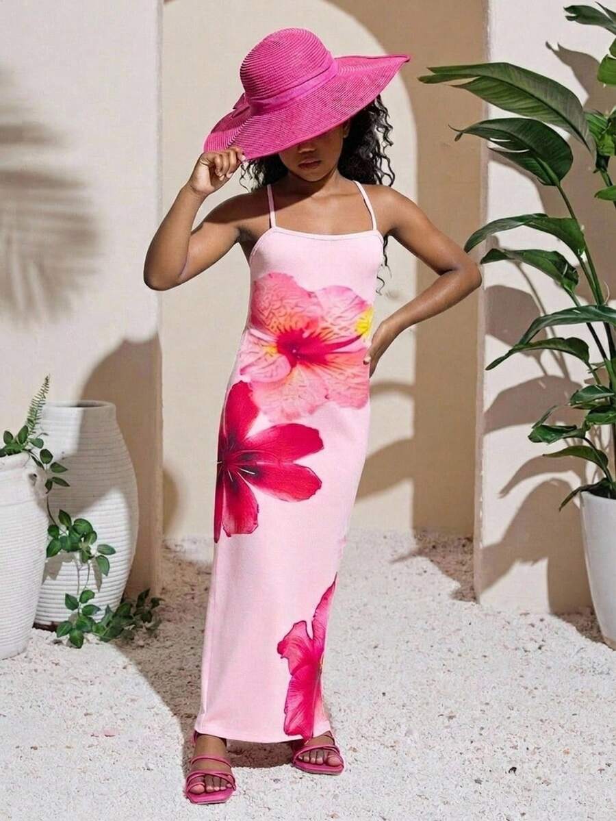 Tween girls black cami midi dress featuring plant print, spaghetti straps, slim fit, and a flared hem.