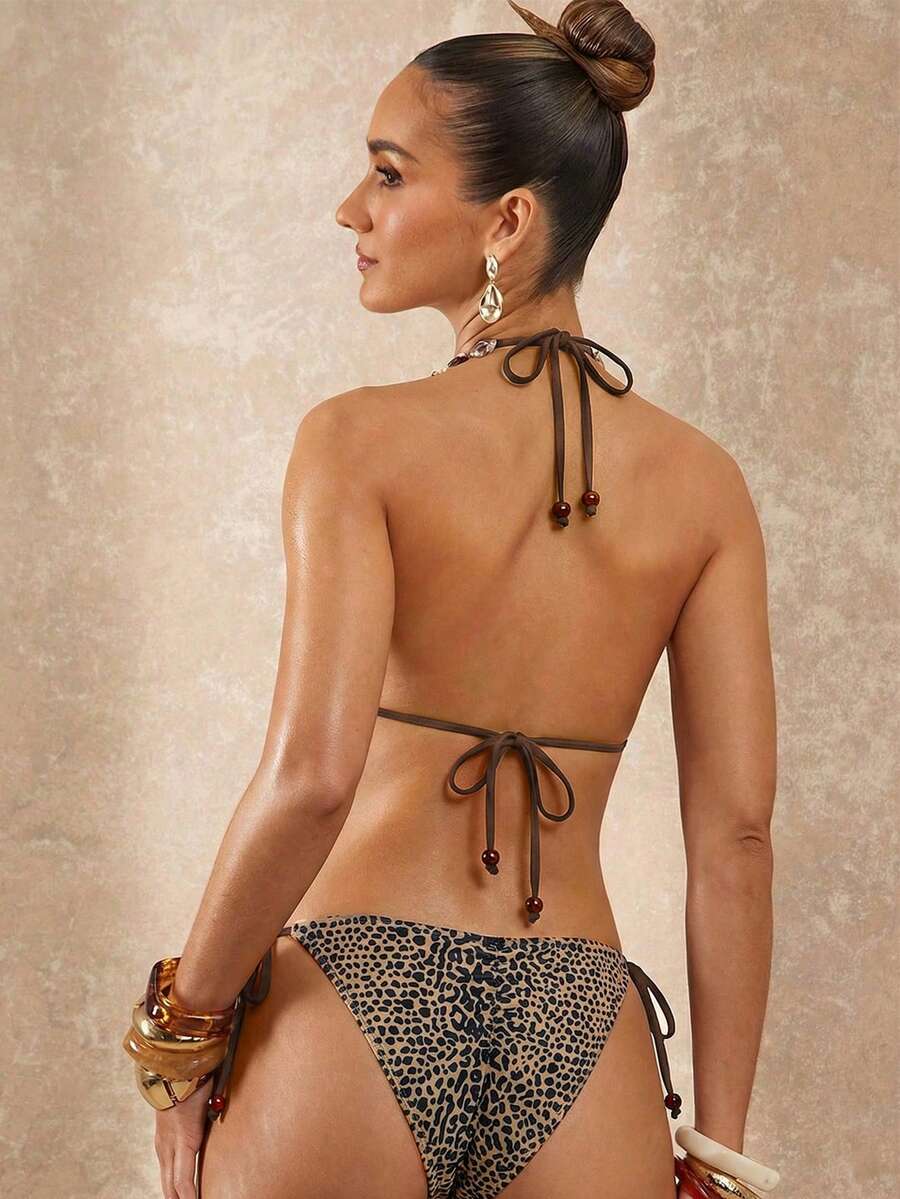 Women's black and white halter triangle bikini top and high waist tie side thong bottoms set.