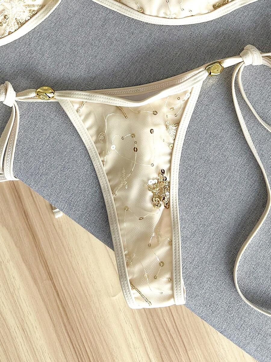 Apricot 2-piece sequin textured halter bikini set featuring a wireless top with lace-up backless ties and matching low-waist side-tie thong bottoms.