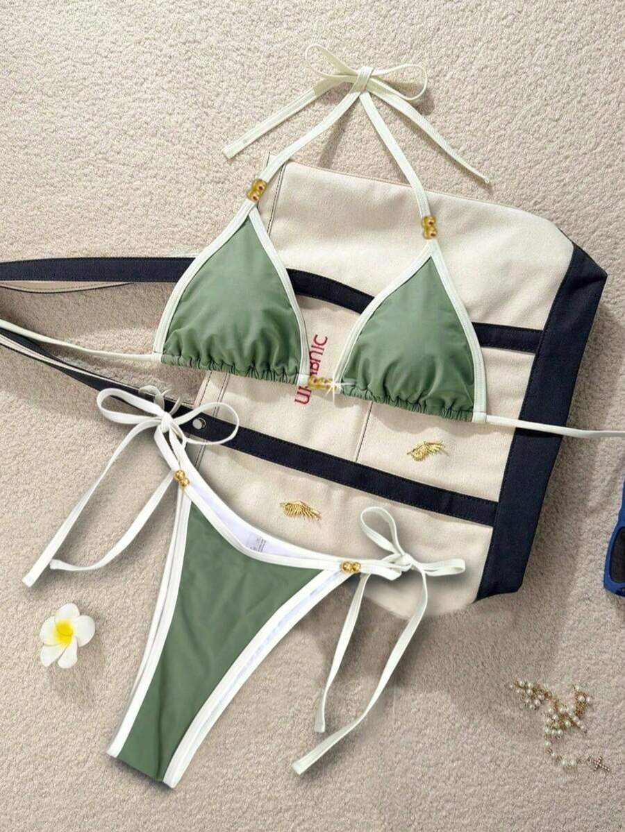 Women's black halter bikini set featuring triangle cups with gold bead decor and tie-back closure