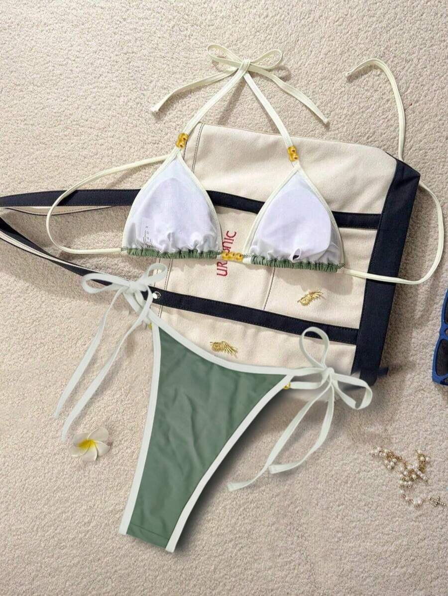 Women's black halter bikini set featuring triangle cups with gold bead decor and tie-back closure