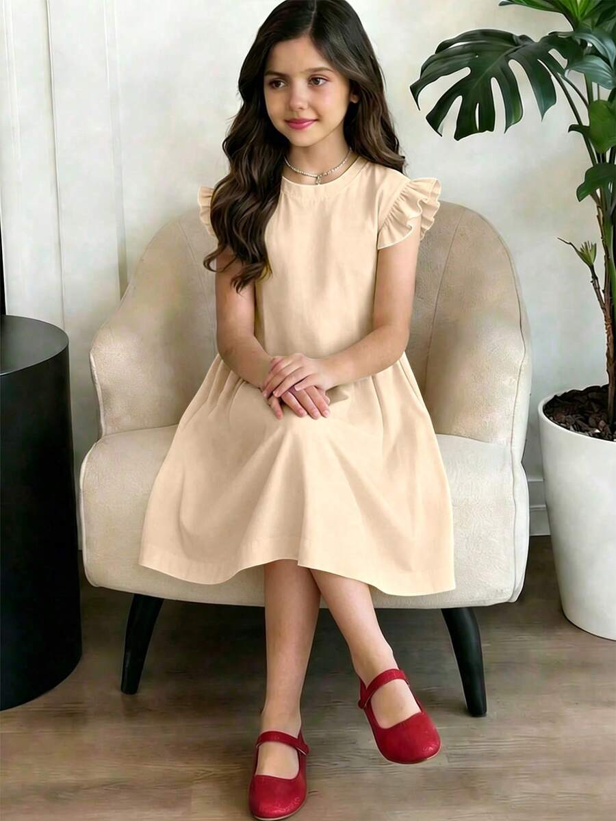 Girls black ruffle sleeve midi dress featuring a loose fit tunic silhouette, round neckline, button details, and short flounce sleeves.