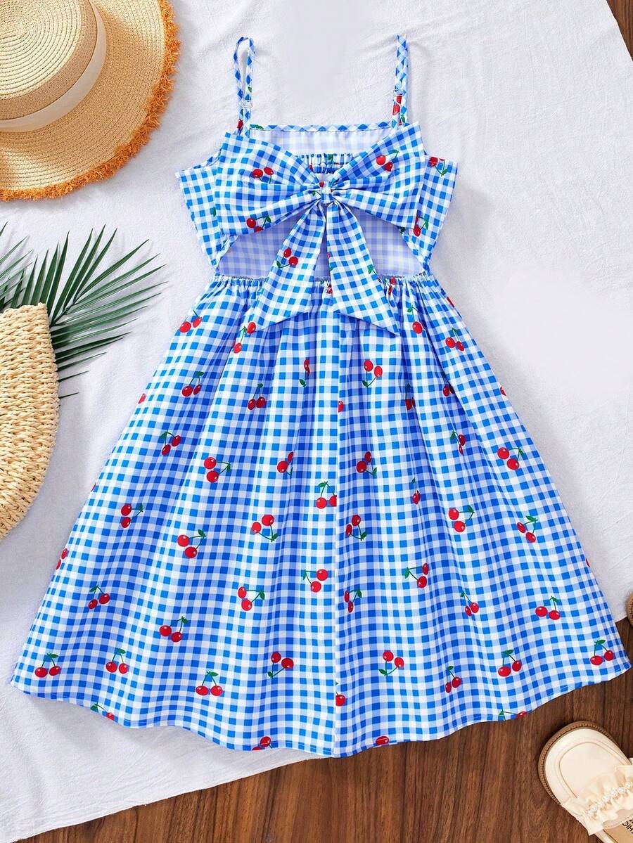 Tween girl wearing an apricot floral print sleeveless mini cami dress featuring spaghetti straps, a shirred high waist, flounce hem, and a bow back detail.