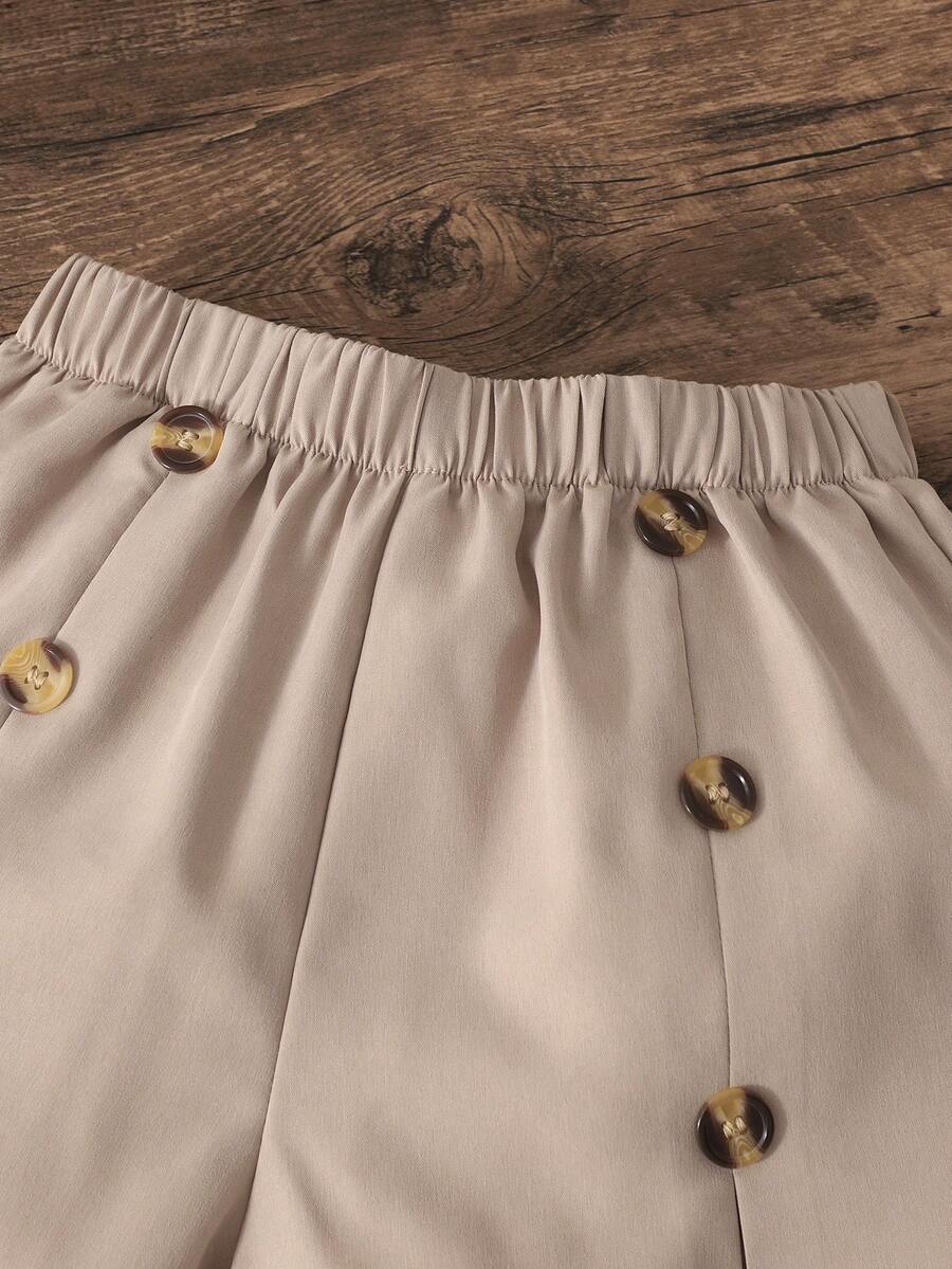 Apricot two-piece summer outfit for tween girls featuring a sleeveless pleated square-neck camisole top with button details and matching gathered shorts.