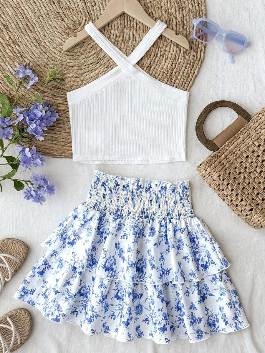 Tween girls blue and white 2-piece set with a striped halter neck vest top and a floral high-waist tiered paperbag skirt.