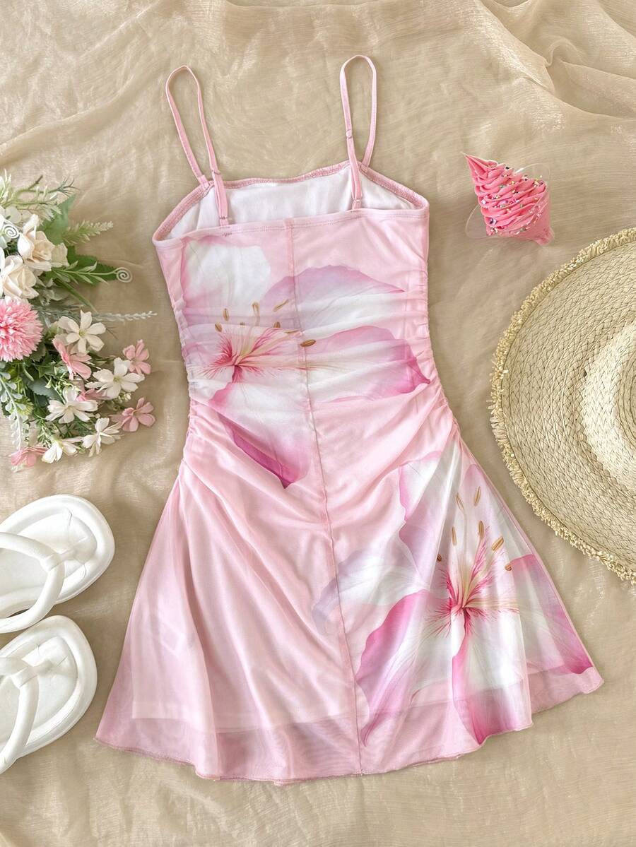 Tween girl yellow mini sundress with large pink floral hibiscus print, spaghetti straps, high waist, flared hem, and sleeveless cami style for summer beach wear