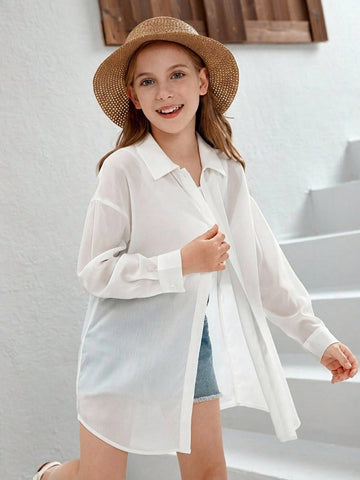 Front view of a white drop shoulder button-front long sleeve shirt for tween girls featuring a collar neckline and asymmetrical hem.