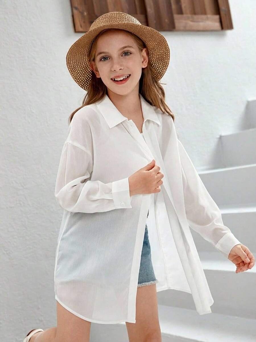Front view of a white drop shoulder button-front long sleeve shirt for tween girls featuring a collar neckline and asymmetrical hem.