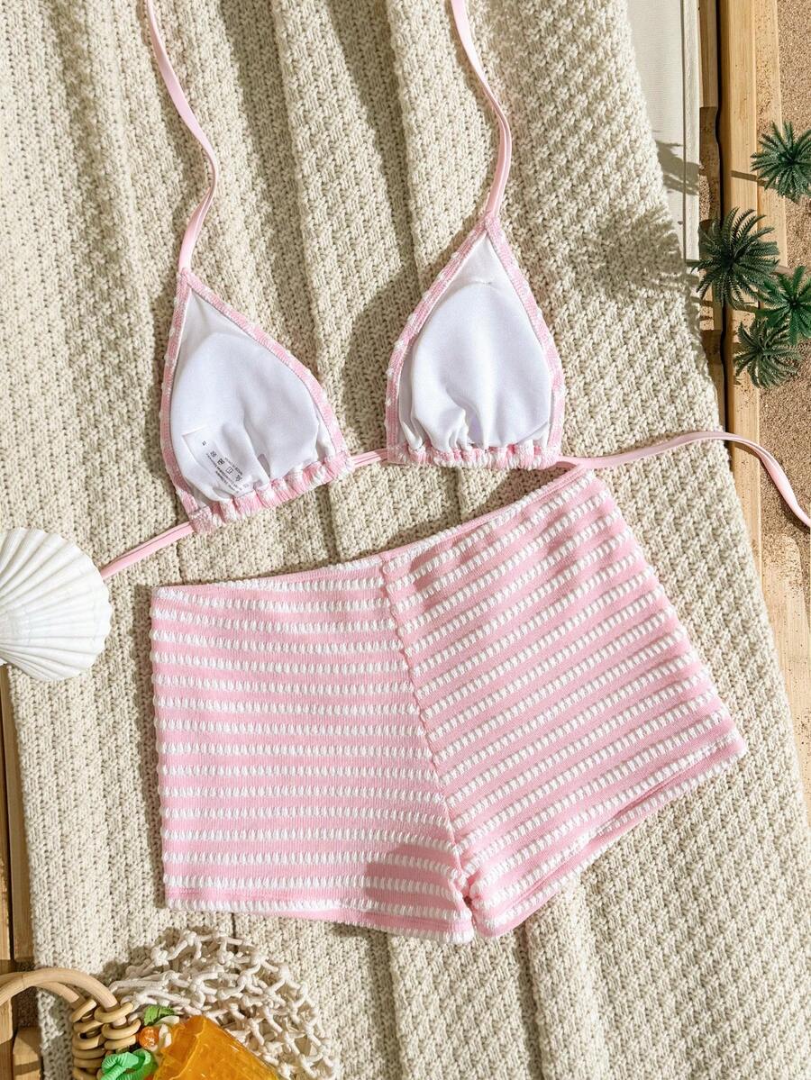 Women's apricot two-piece swimsuit set with a halter tie-back top and matching high stretch shorts.