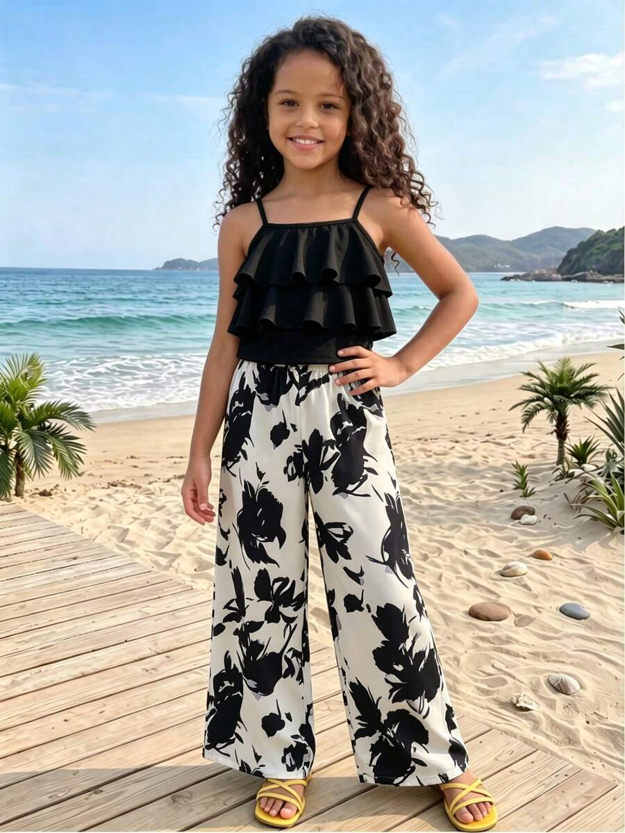Tween girls blue 2-piece vacation outfit set featuring a tiered ruffle spaghetti strap camisole and loose high-waist pants.