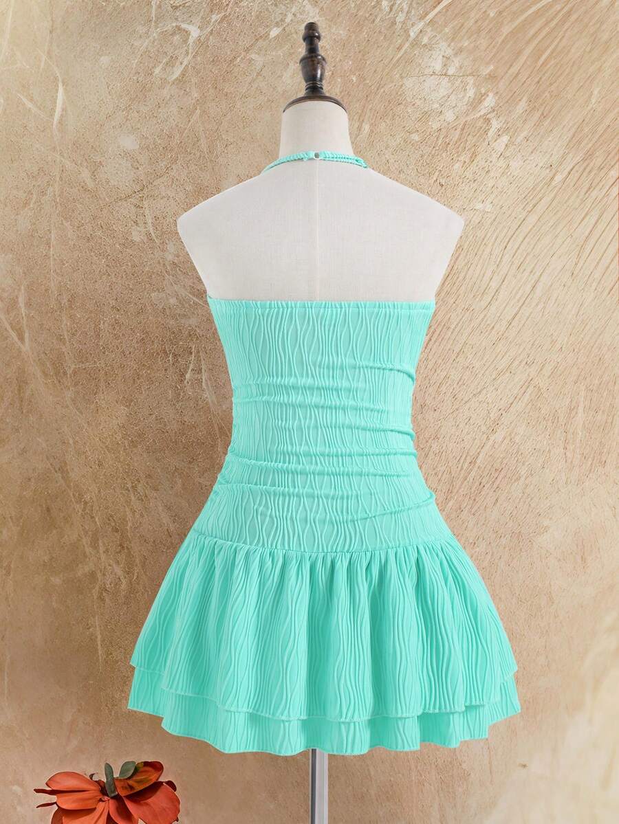 Tween girls apricot sleeveless halter mini dress with textured starfish and shell decor, shirred tiered layer, high waist, and flounce hem.