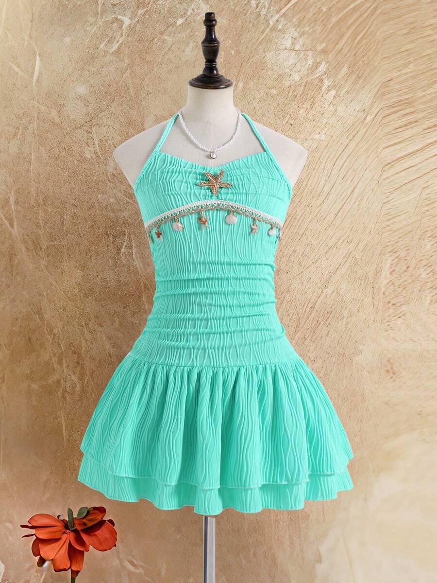 Tween girls apricot sleeveless halter mini dress with textured starfish and shell decor, shirred tiered layer, high waist, and flounce hem.