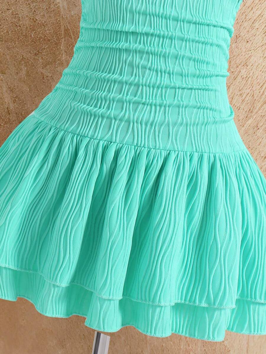Tween girls apricot sleeveless halter mini dress with textured starfish and shell decor, shirred tiered layer, high waist, and flounce hem.