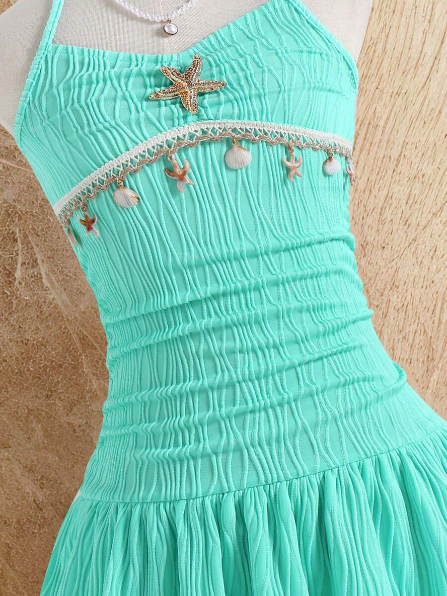 Tween girls apricot sleeveless halter mini dress with textured starfish and shell decor, shirred tiered layer, high waist, and flounce hem.